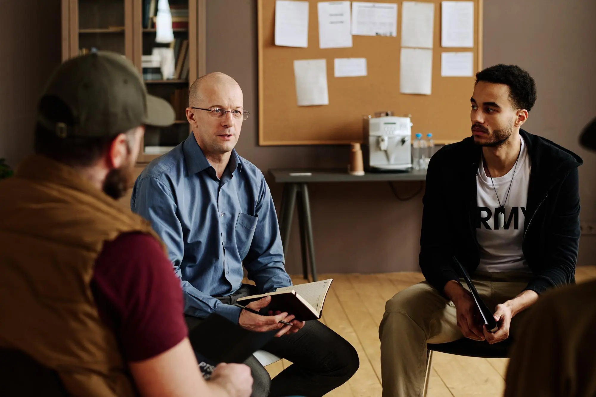 confident mature male counselor consulting people with post traumatic syndrome 274679 40014